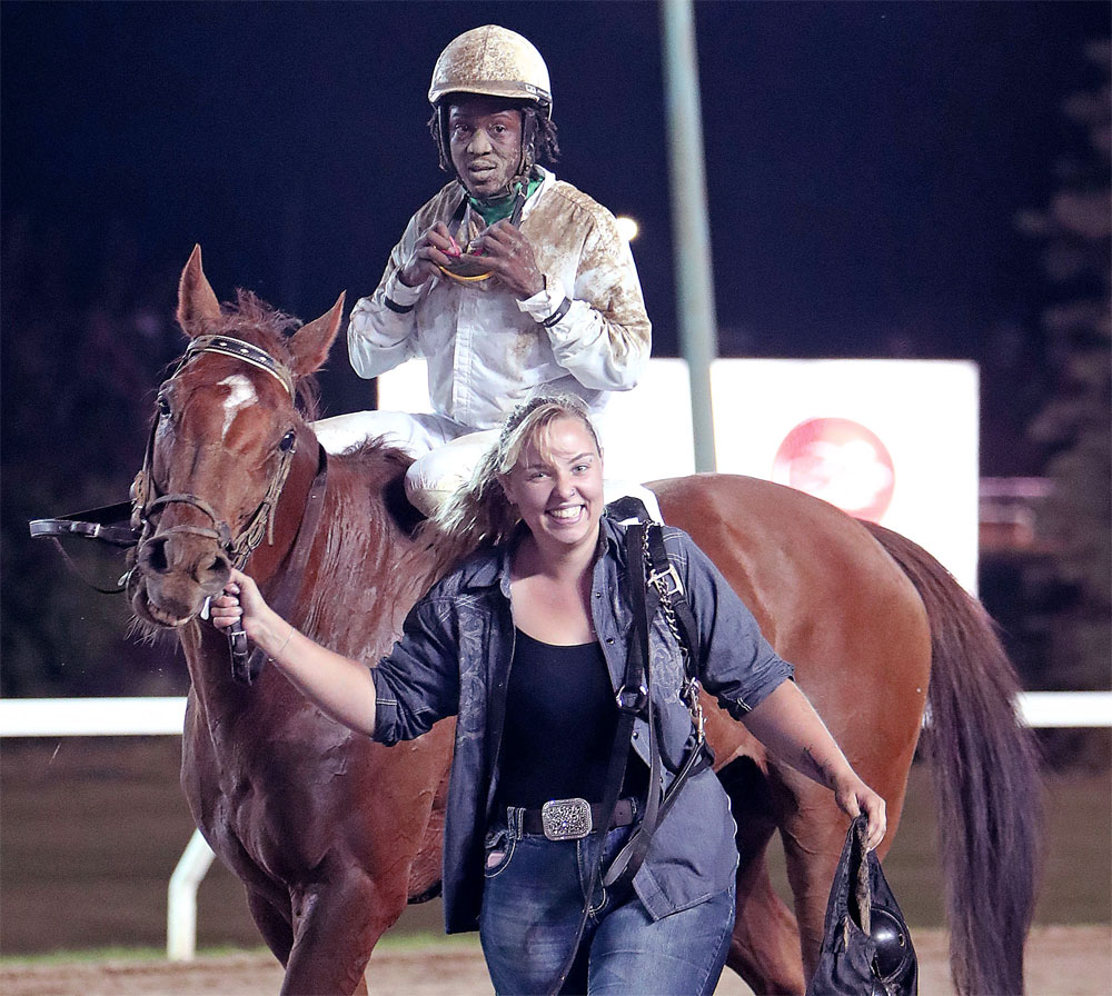 CaptiveKittenCharlotteJohnston1k Captive Kitten, jockey Javaniel Patterson, and groom Charlotte Johnston enter the winner’s circle after winning the 7th race on Tuesday, triggering a monster Pick 4 payoff. (Jason Halstead / Assiniboia Photo)